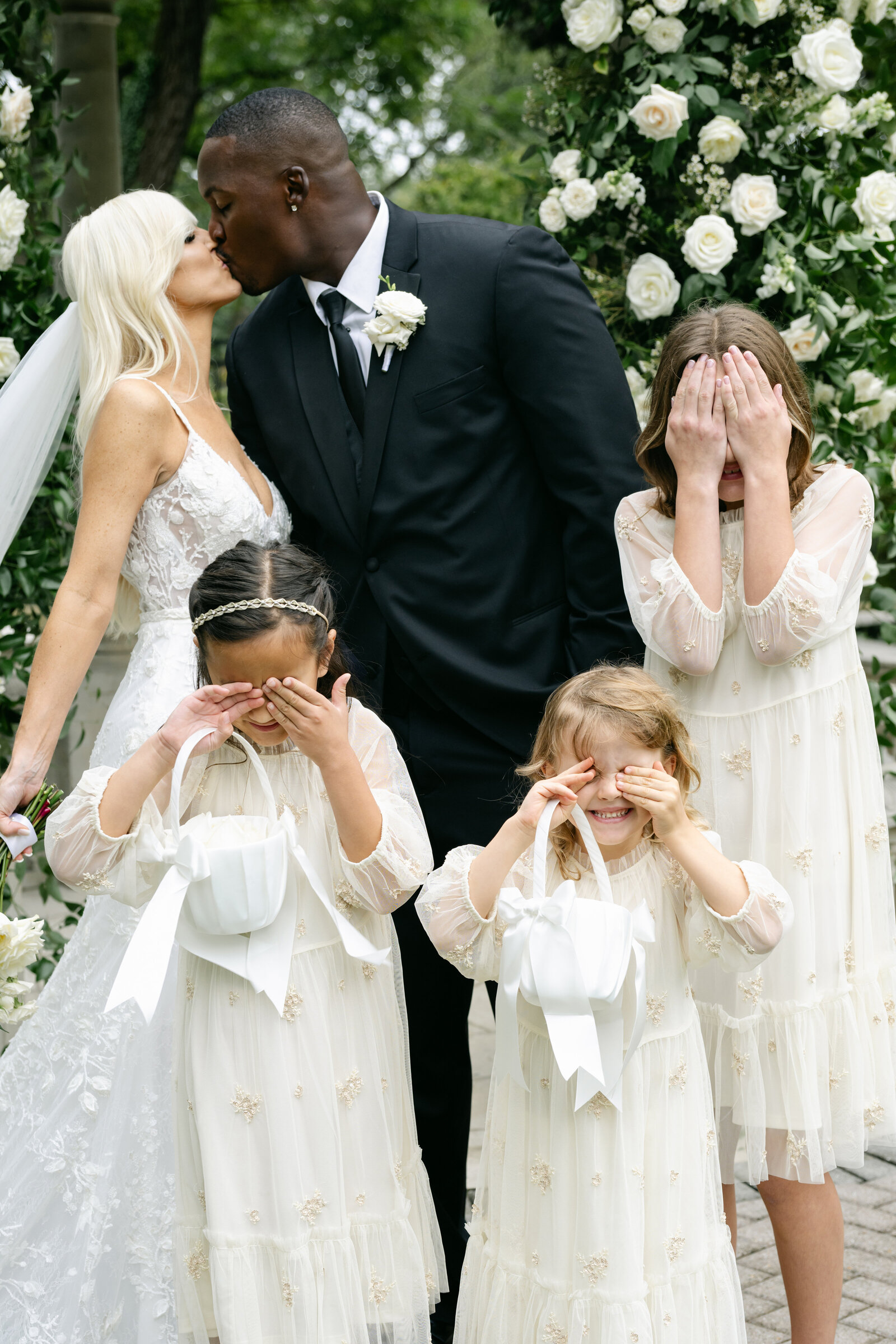 The first kiss as a married couple, and four flower girls deciding all at once that they would rather not look.